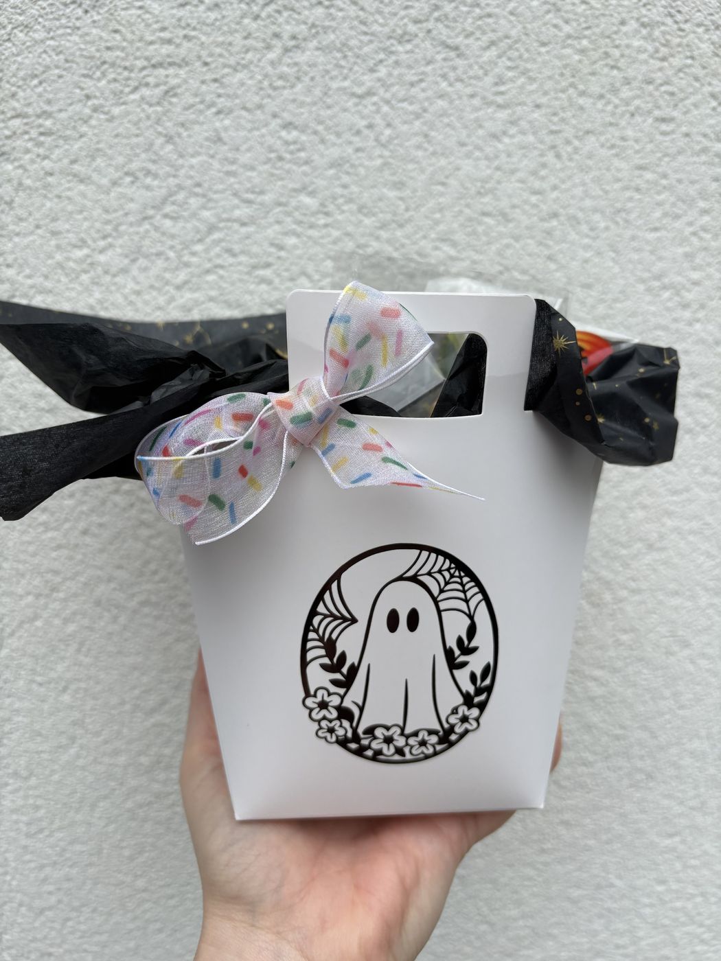 White Halloween Boo Bag gift box with ghost design, tied with a sprinkle-print bow