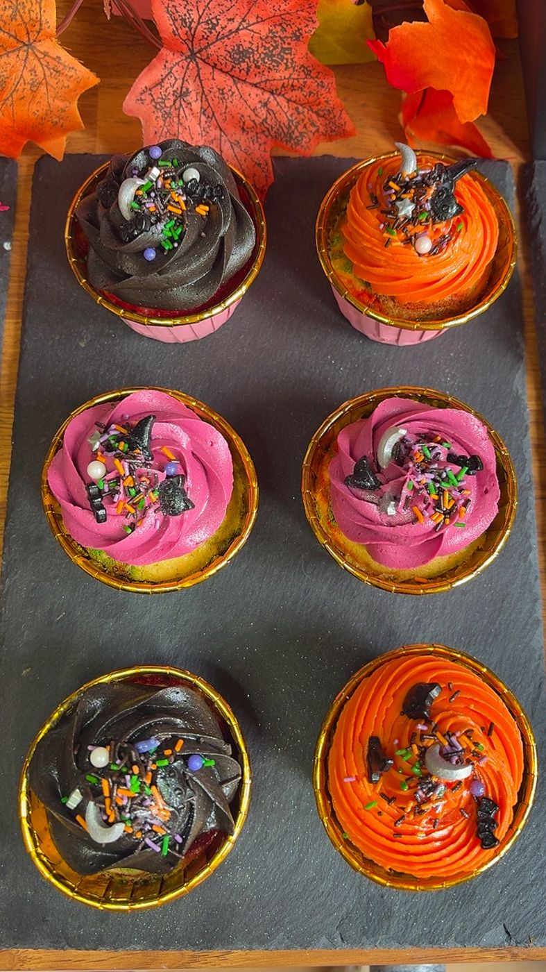 Pick Your Poison Halloween cupcakes with black, orange and pink buttercream swirls