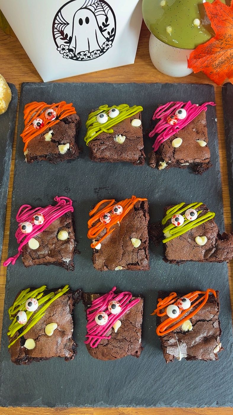 Boo Brownie Bites decorated with candy eyeballs and colourful monster hair drizzle