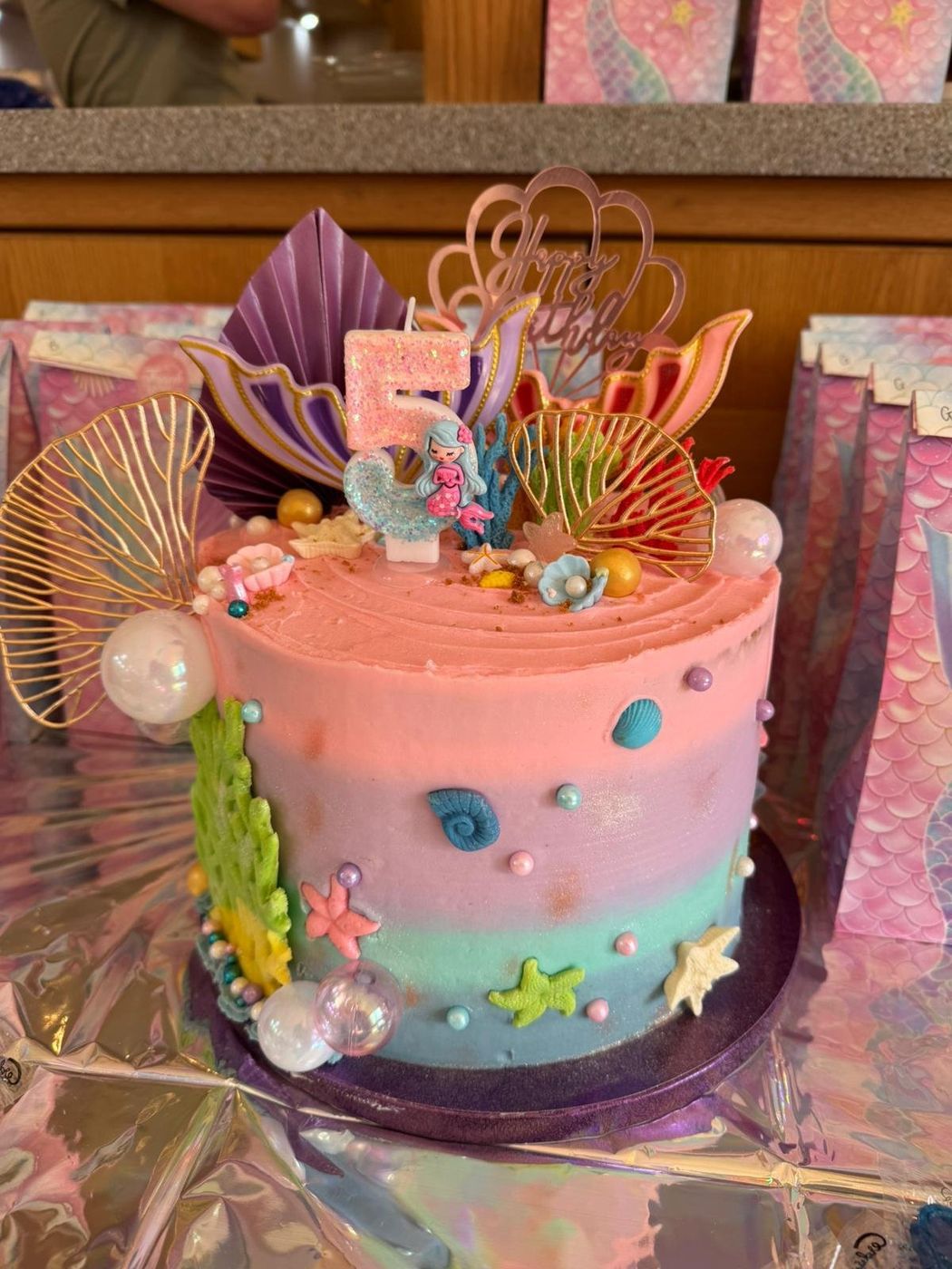 Under-the-sea mermaid themed 5th birthday cake with shell and coral decorations