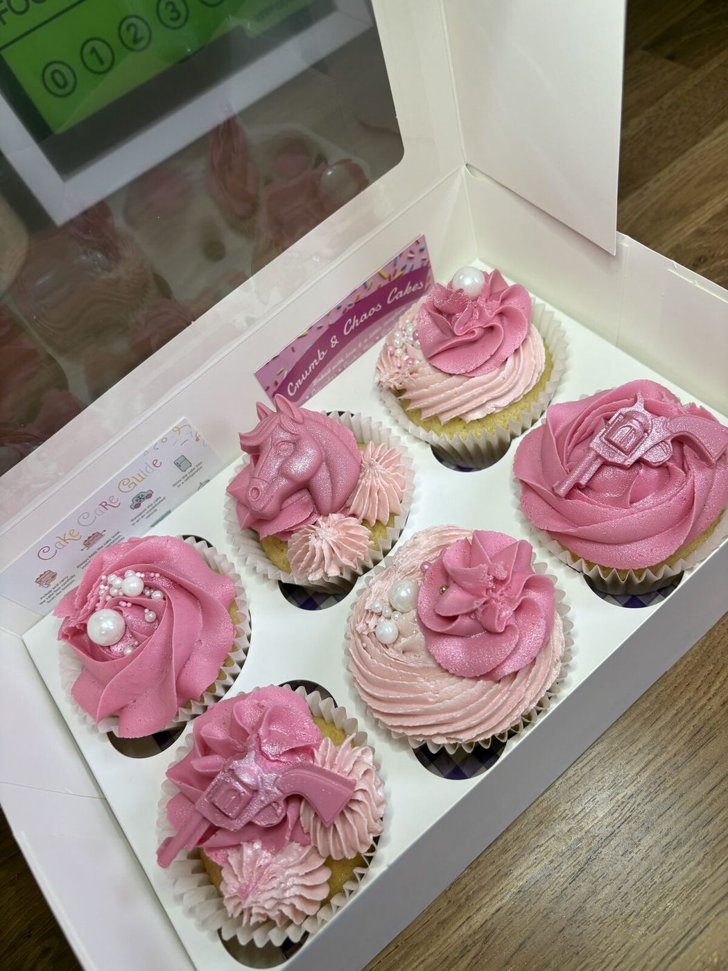 Pink glitter cowgirl themed cupcakes with horse and horseshoe toppers