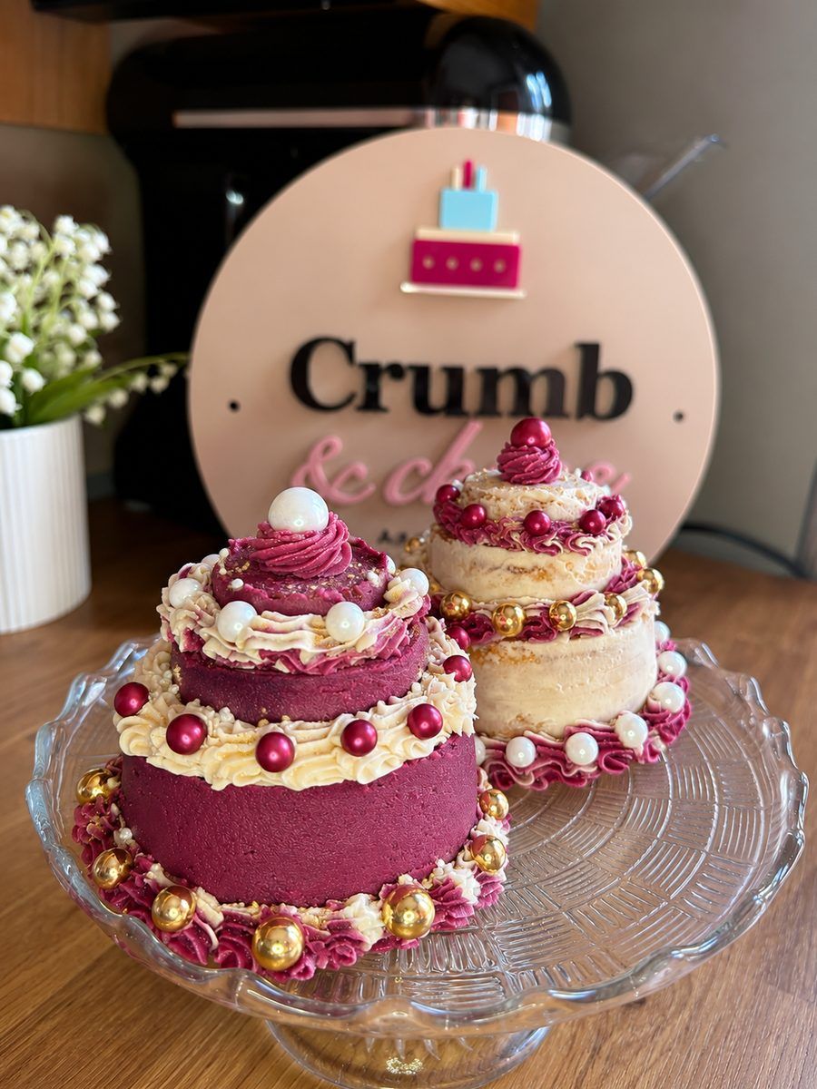 Custom two-tier mini celebration cakes in burgundy and gold
