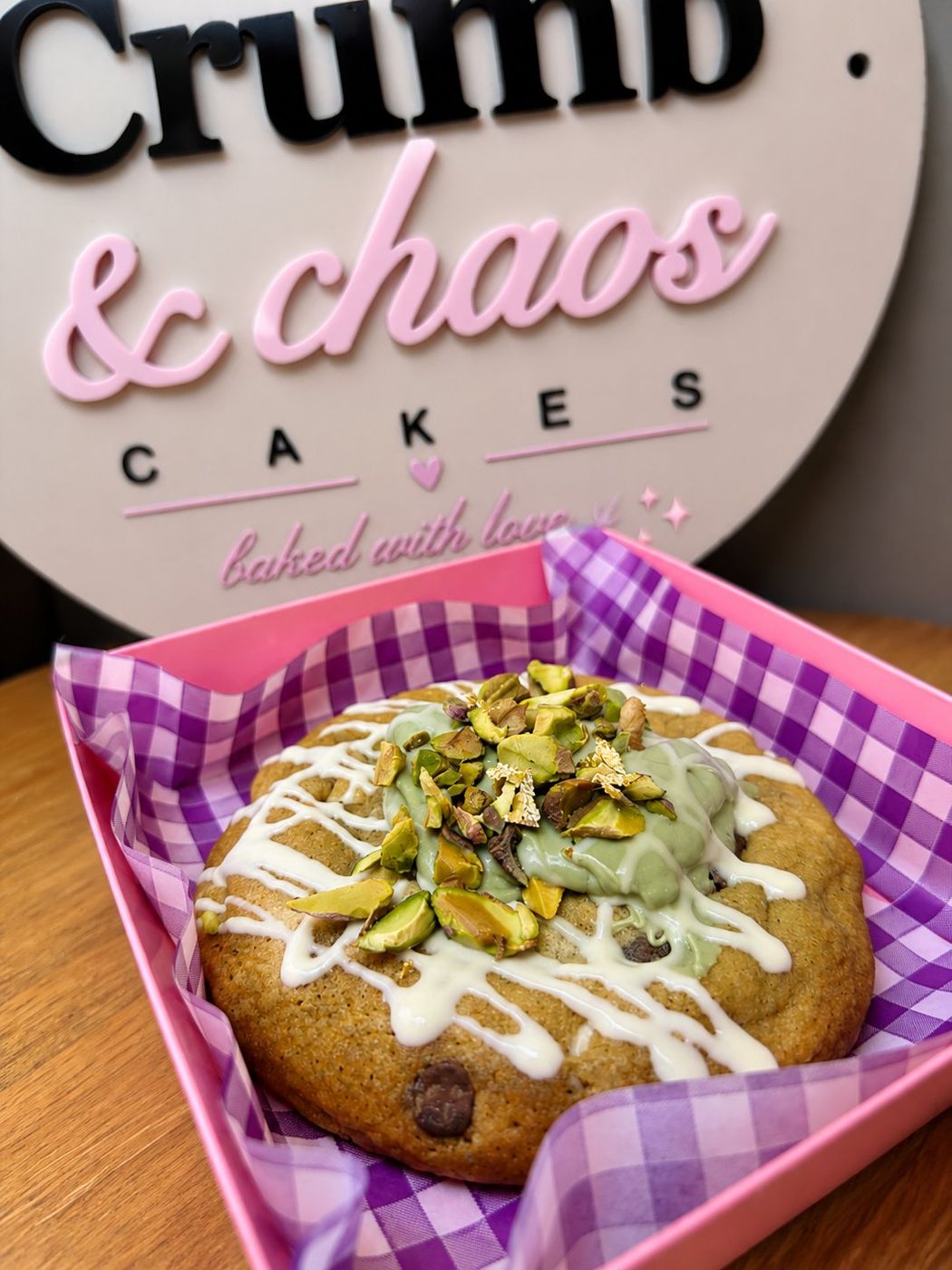 Loaded cookie topped with pistachio cream, chopped pistachios and gold leaf