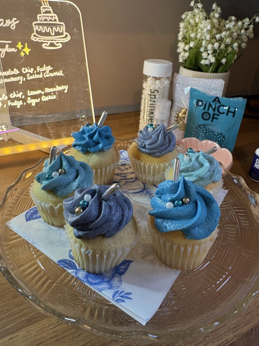Box of micro cupcakes with blue and silver rosette buttercream